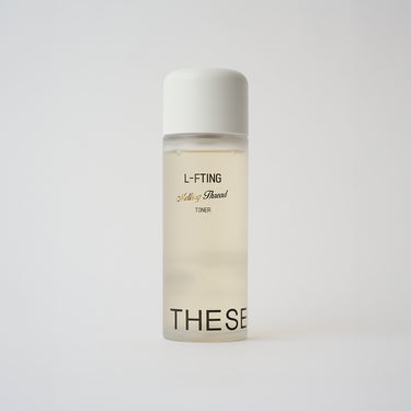 yellow liquid skincare in a clear bottle with a white top