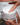 model placing finger into skincare container