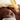 holding skincare product next to client's face with soap on their face 