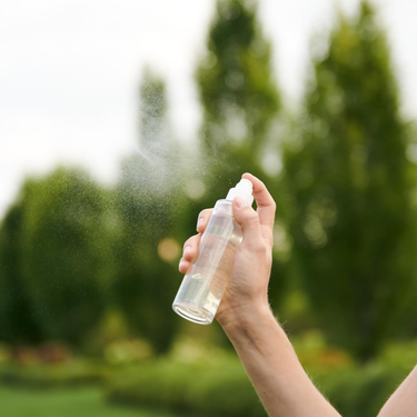 spraying skincare product into the air 