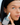 girl holding skincare product close to her face modeling 