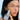 girl holding skincare product close to her face modeling 